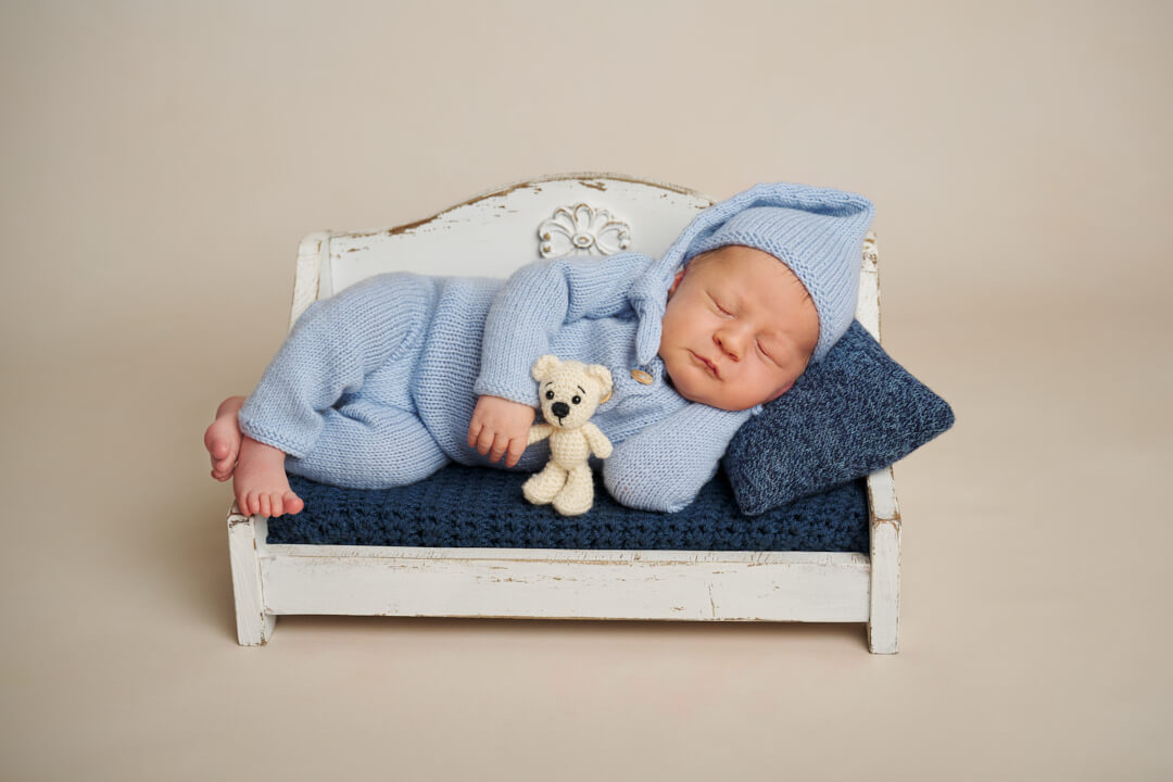 Neugeborenen Fotoshooting, Newborn Fotoshootings, Baby auf Vintage Bank mit blauen Farben, Babyfotografie Ingolstadt Mandy Limbach